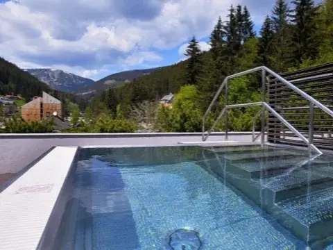Venkovní bazén s výhledem na hory v hotelu PECR Well